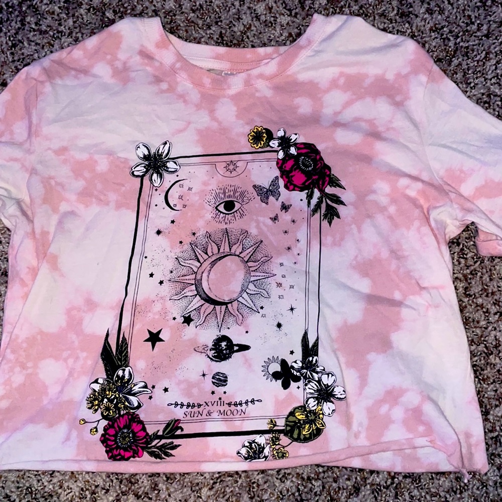 This is a really cute tie-dye shirt with a graphic on the front of it.